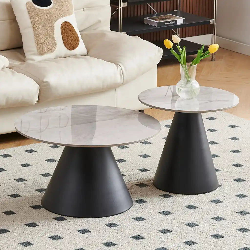 round coffee table set with marble tops and black cylindrical bases for living room