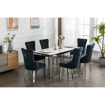 Dining room set with a white marble top stainless steel legs table and black velvet dining chairs 
