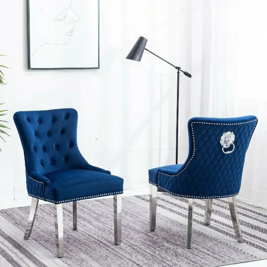 Set Of Two blue Accent chairs with tufted backs and lion emblem