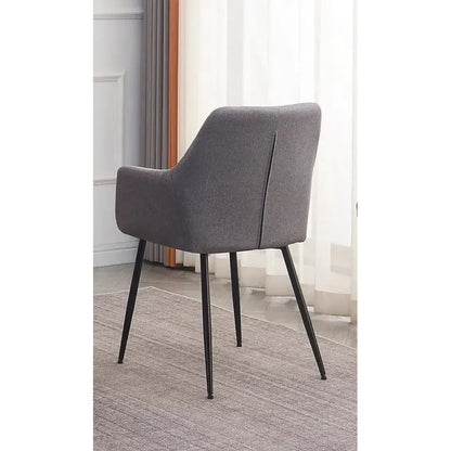 back of Grey upholstered chair with black metal legs 