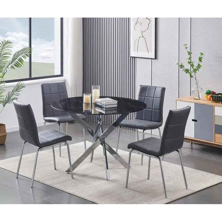 Dining room set with a round black table and four grey PU chairs.