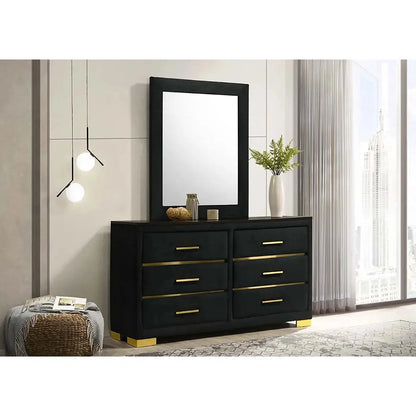 Black dresser with gold accents and a mirror