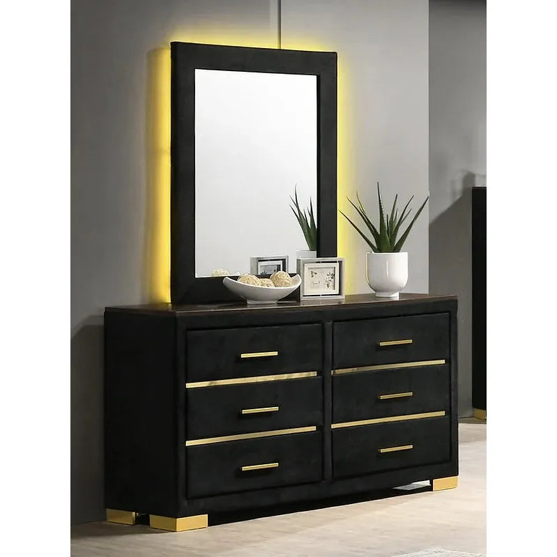 Black dresser with mirror gold accents and a mirror 