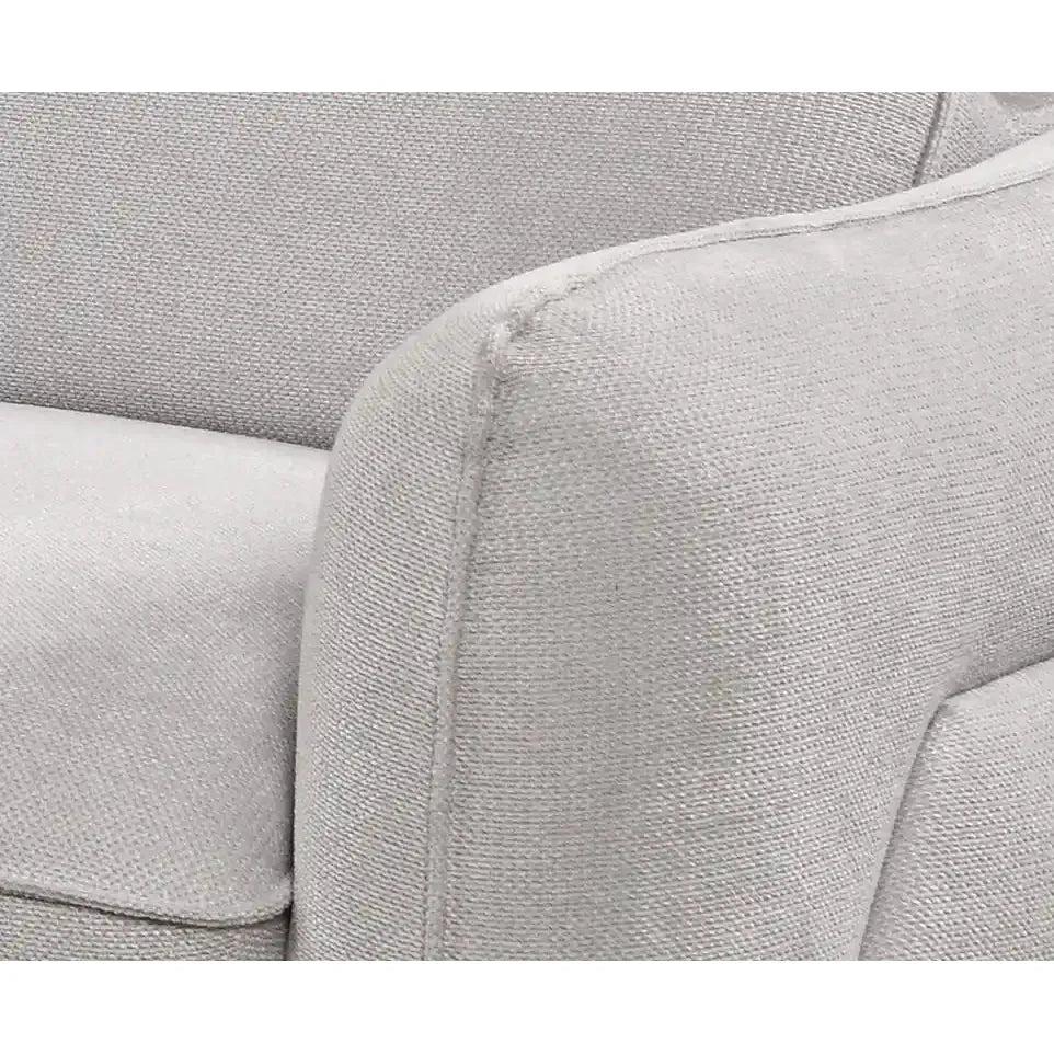 Close-up of a gray fabric sofa with visible stitching.