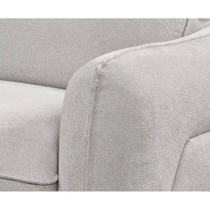Close-up of a gray fabric sofa with visible stitching.