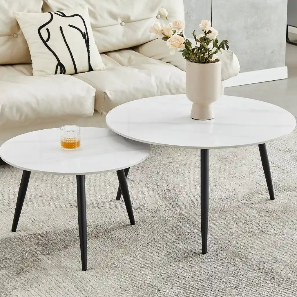 Set of two white round coffee tables with black legs 