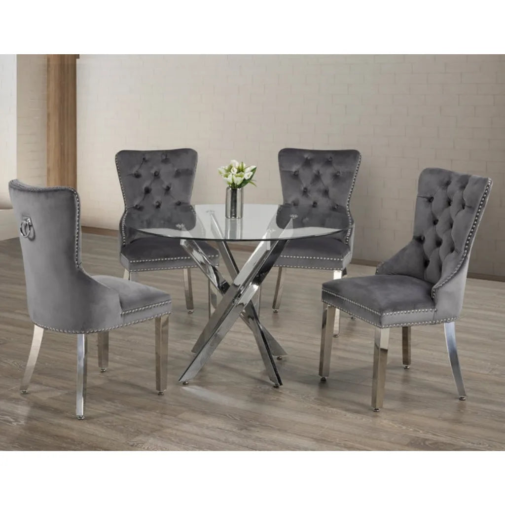 Dining set with gray tufted chairs and a round glass table 