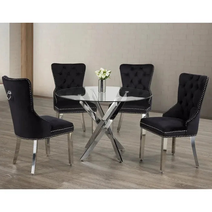 Dining set with black tufted chairs and a round glass table