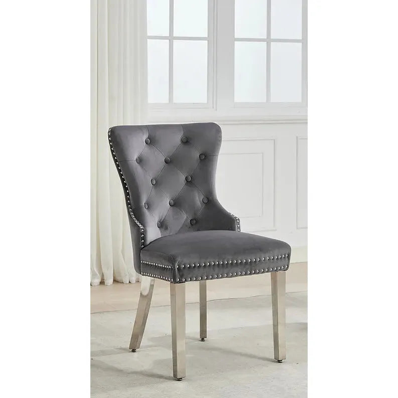 Gray upholstered chair with nailhead trim in a bright room