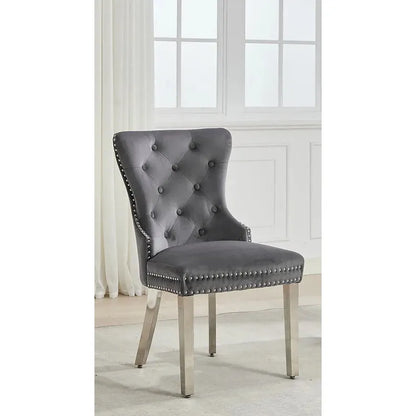 Gray upholstered chair with nailhead trim in a bright room
