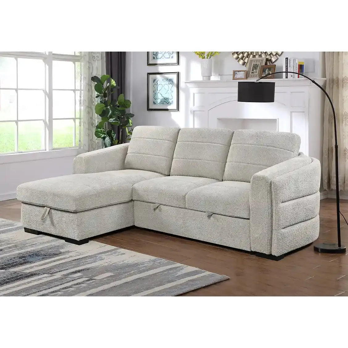 Grey sectional sofa in a living room setting with a fireplace and decor.