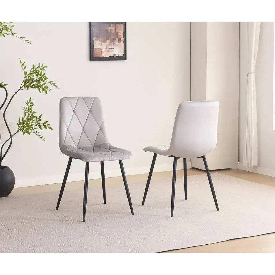 Two light gray dining chairs 