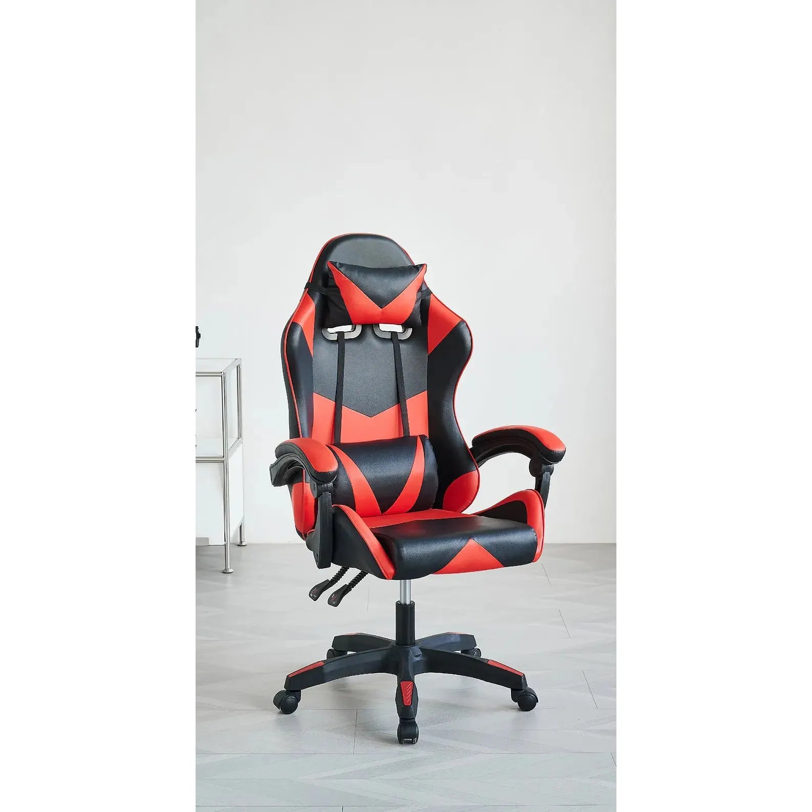 Black and red gaming chair with a white wall background