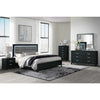 Modern bedroom with black and gray furniture set, including bed, nightstands, and dresser.