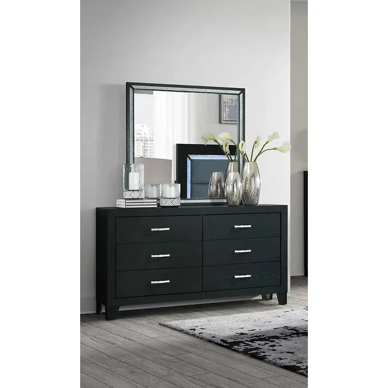 Black dresser with mirror in a room setting