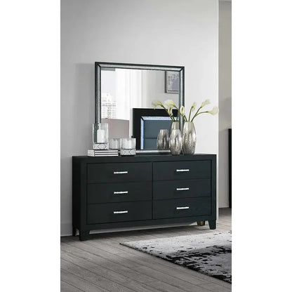 Black dresser with mirror in a room setting