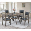 Dining room set with a round wooden table and four chairs with black seats.