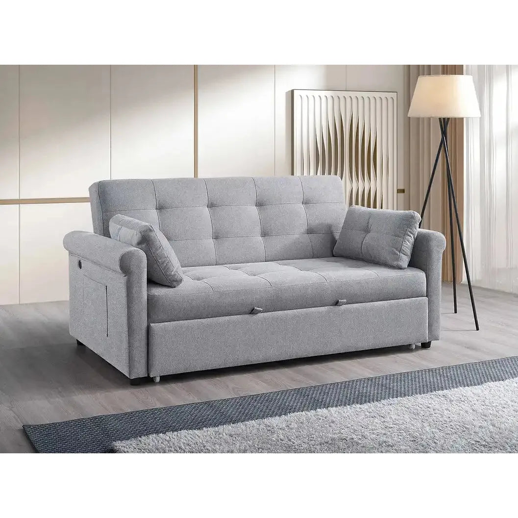 Gray sofa bed in a room with a lamp and wall art.