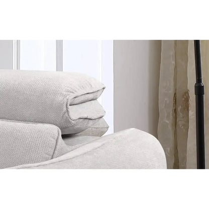 Stack of light gray textured pillows on a white surface with a neutral background