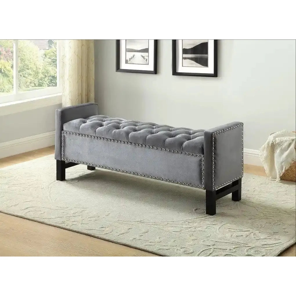 Grey tufted bench with nailhead trim