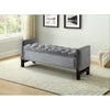 Grey tufted bench with nailhead trim