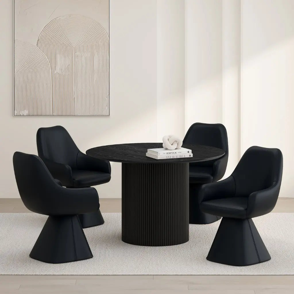Modern black dining table with four matching chairs in a minimalistic room.