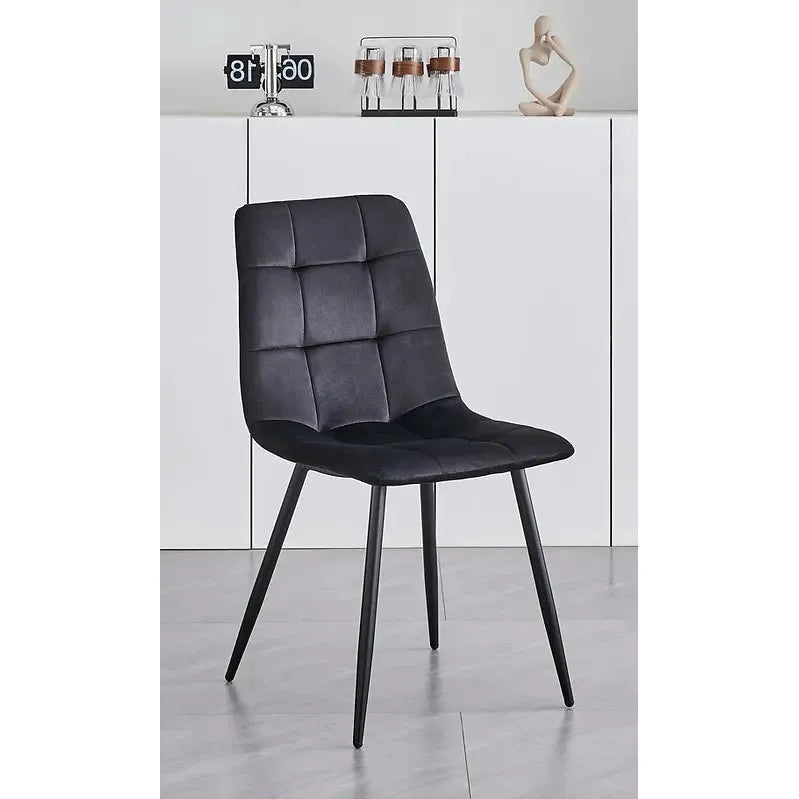 Black upholstered velvet chair with quilted design 