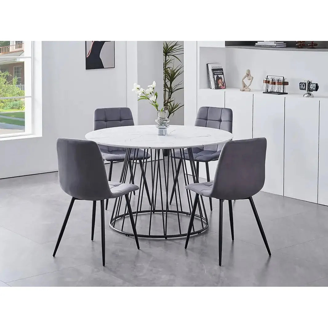 Dining room set with a round white table and gray velvet chairs
